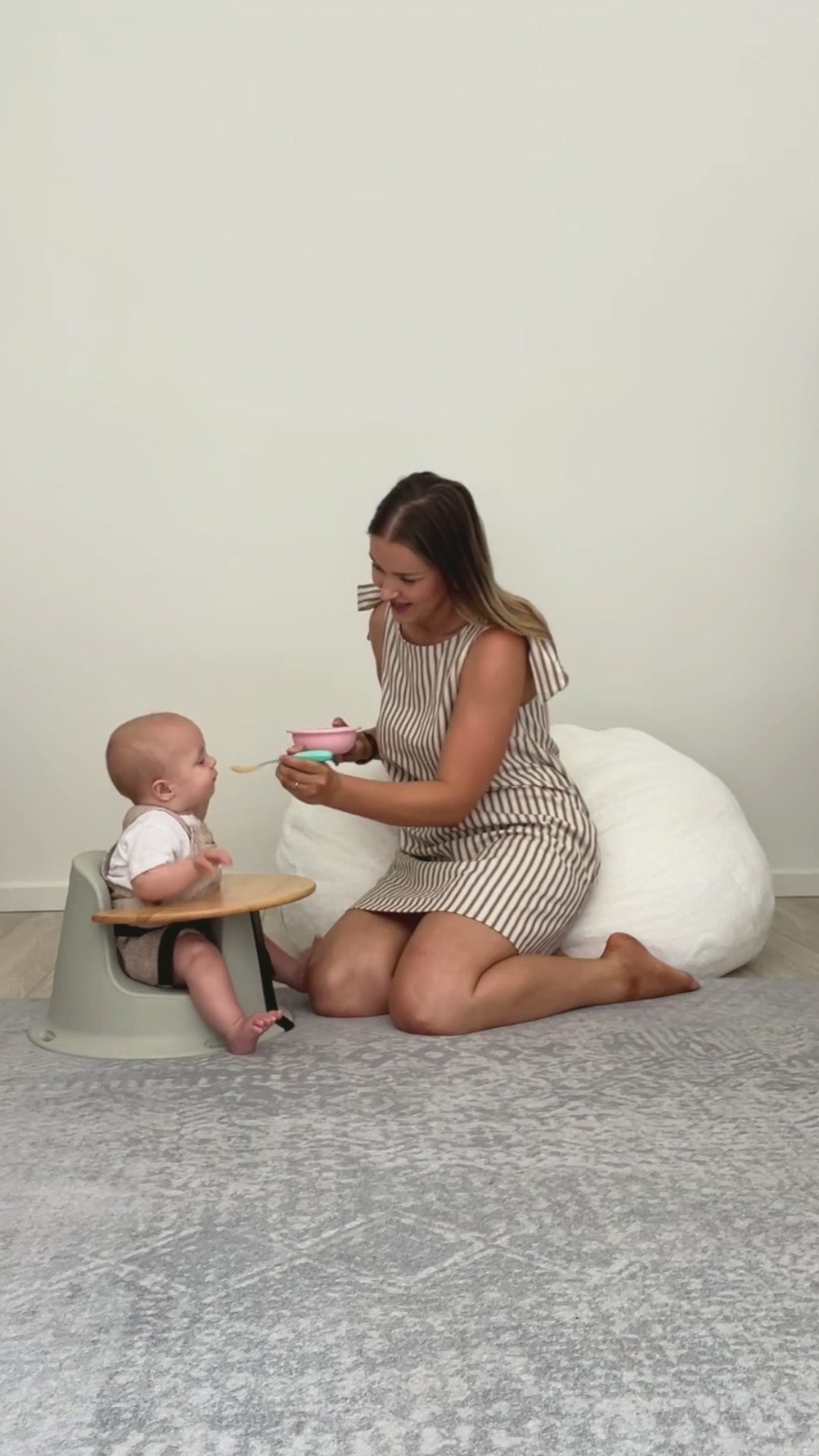 mum feeding baby in floor seat